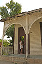 Girl in Doorway Caribbean Wooden House