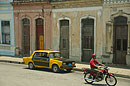 Taxi and Red Top Motorcyclist