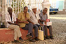 4 Men Sitting on a Wall Trinidad Cuba