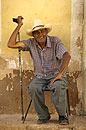 Cuban Man with Stick on a Seat
