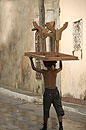 Boy with Table Upturned on Head