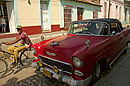 Bike Passing Classic Car Cuba