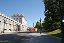 Red Tourist Bus Turning at Palace Madrid