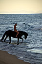 Girl Tourist Riding Horse into Lake