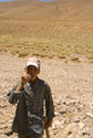 Boy asking for water in the desert