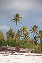 Child in Red by Boat and Palms